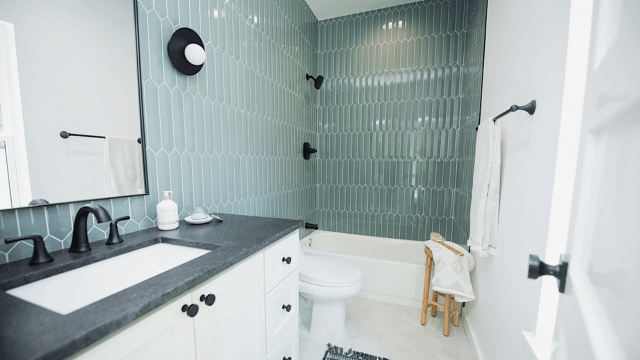 floor to ceiling tile work in shower with new vanity